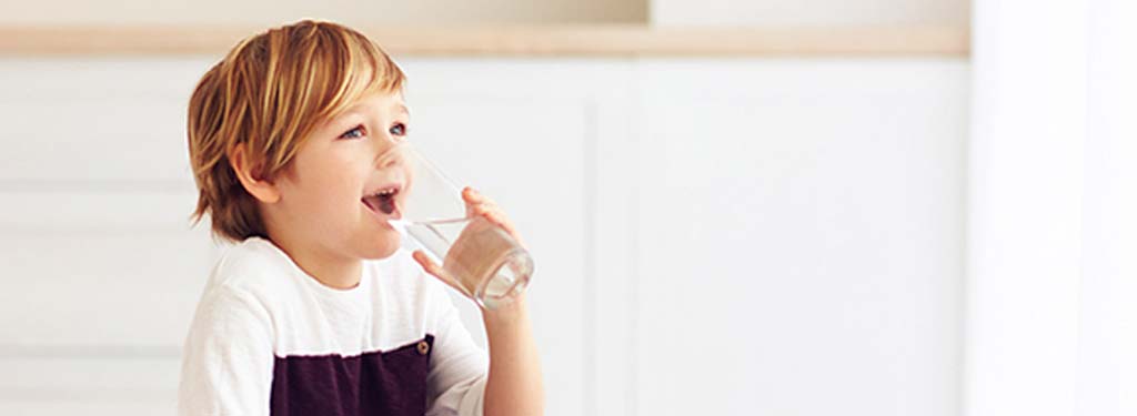 Child drinking a glass of water